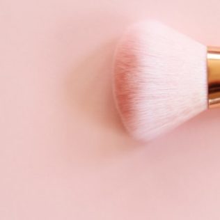 make up brush on pink background at the skin clinic fremantle