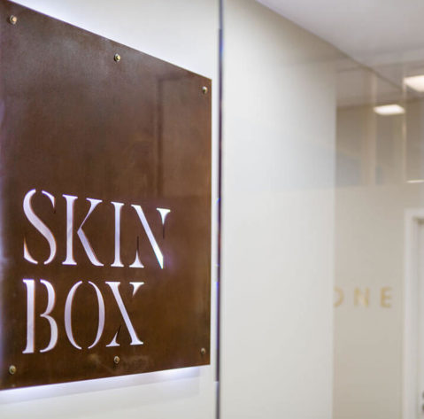 skinbox-entrance-with-rust-logo-and-treatment-room