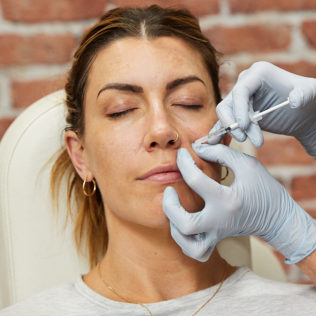 patient receiving facial injectable treatment at skinbox
