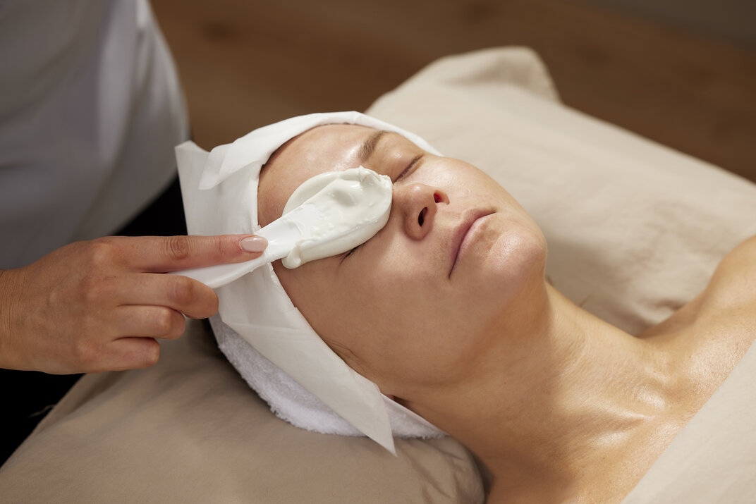 applying Bioalginate mask over a patient's right eye area